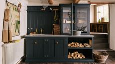 Dark cabinet and natural materials in cottage style utility room
