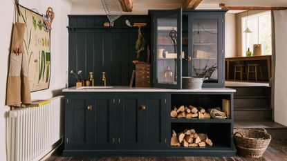 Dark cabinet and natural materials in cottage style utility room