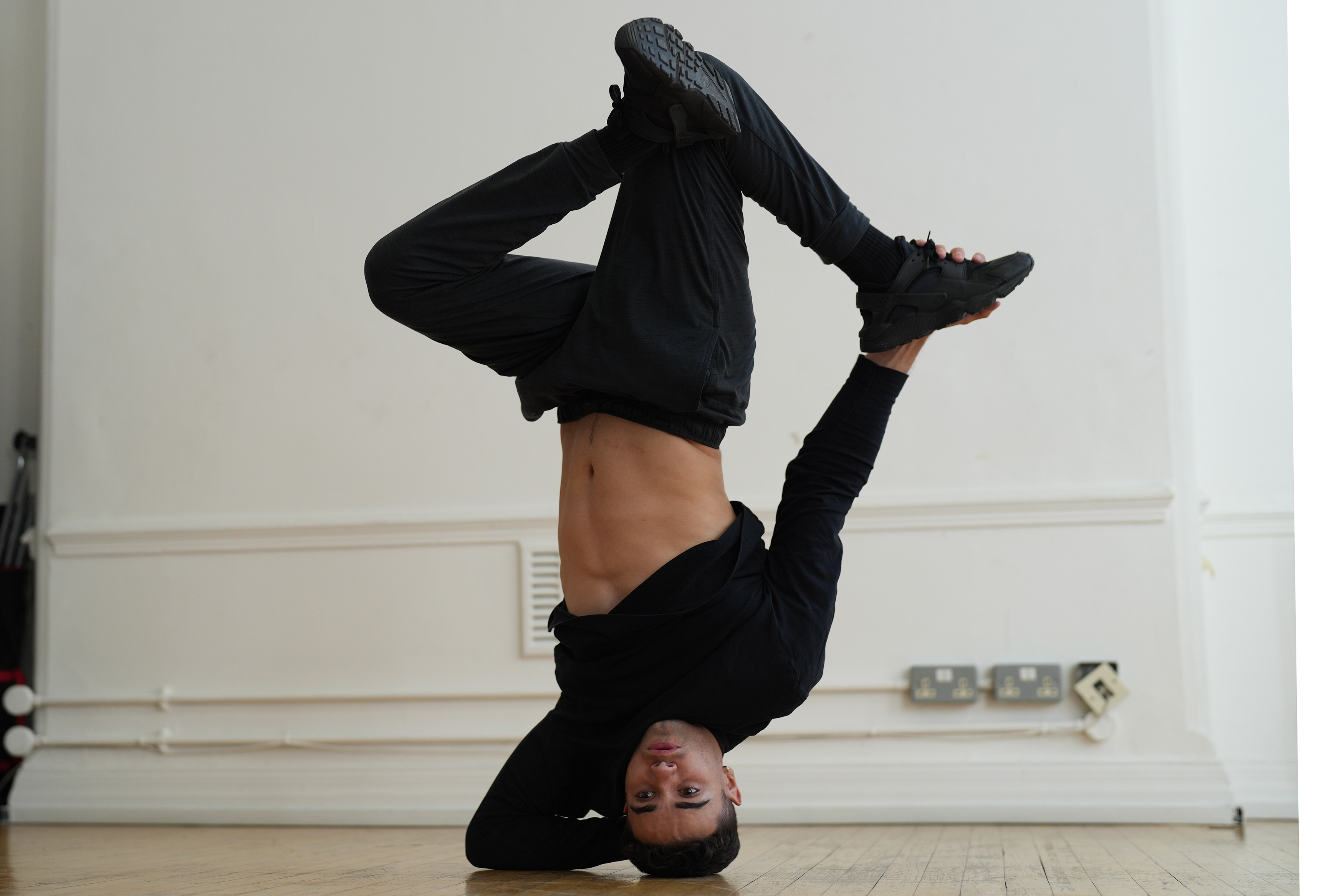 A man break dancing in a studio
