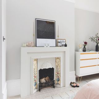 tiled fireplace in pale grey bedroom