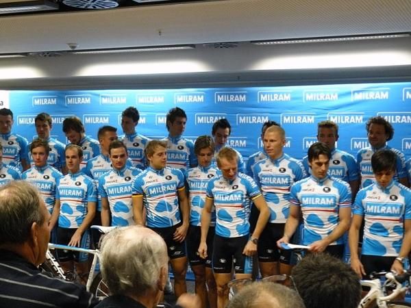 Getting in place for the team photo: who gets to hold the bike?