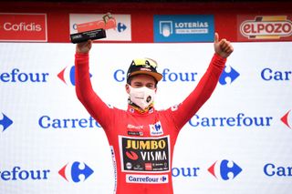 LAGOS DE COVADONGA SPAIN SEPTEMBER 01 Primoz Roglic of Slovenia and Team Jumbo Visma celebrates winning the Red Leader Jersey on the podium ceremony after the 76th Tour of Spain 2021 Stage 17 a 1855km stage from Unquera to Lagos de Covadonga 1085m lavuelta LaVuelta21 on September 01 2021 in Lagos de Covadonga Spain Photo by Tim de WaeleGetty Images
