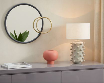 Bobble Table Lamp on sideboard with pink pot and rounded mirror