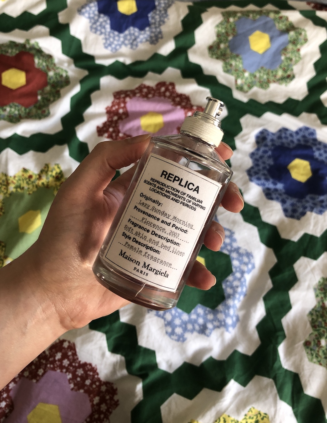 Mica Ricketts holding bottle of Maison Margiela Replica Lazy Sunday Morning EDT