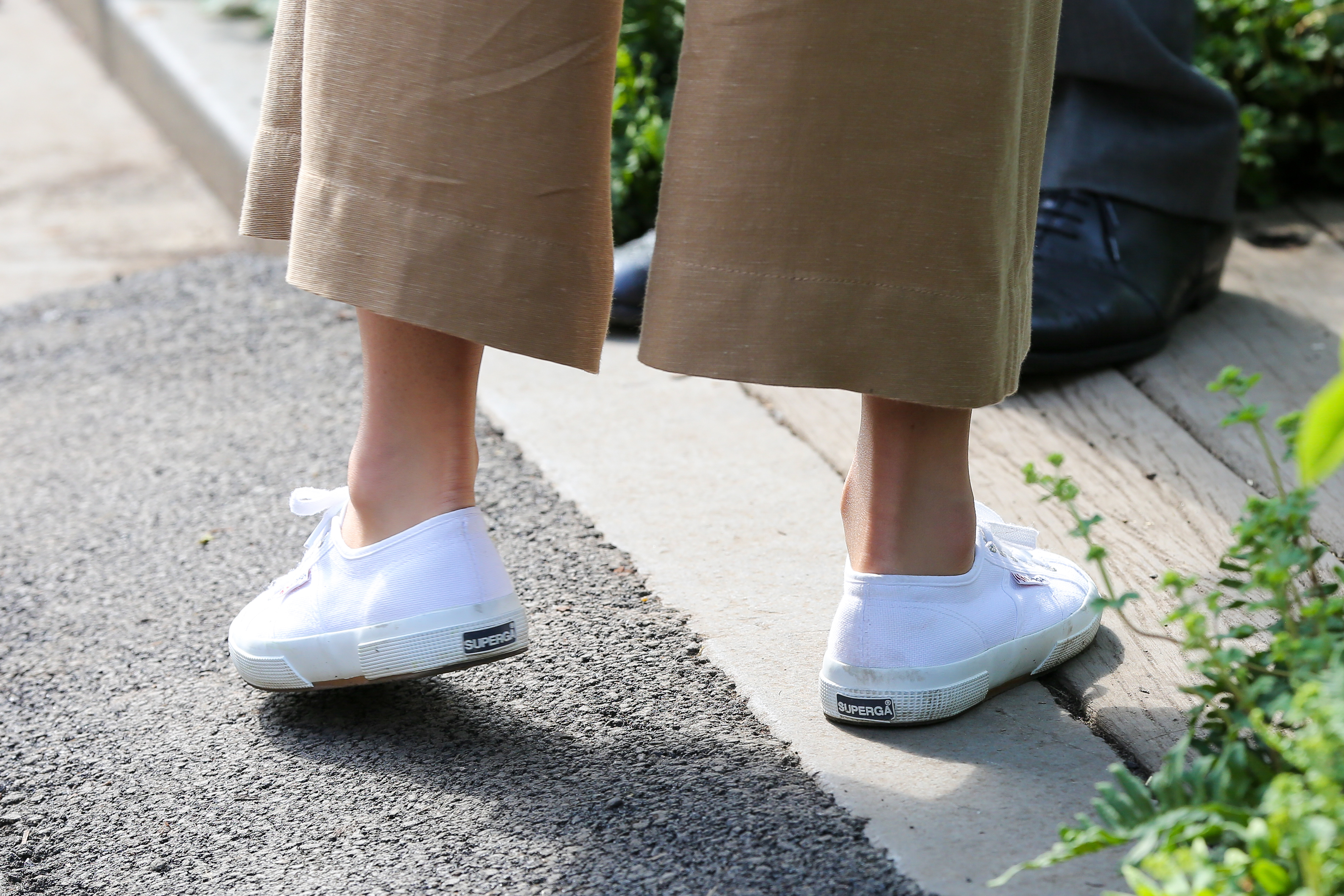 A closeup of Princess Kate's white Superga sneakers and culottes