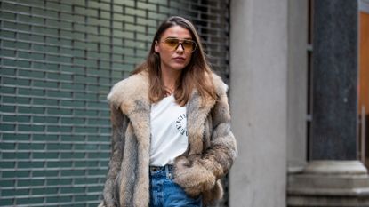 Woman wearing a faux fur jacket outfit.