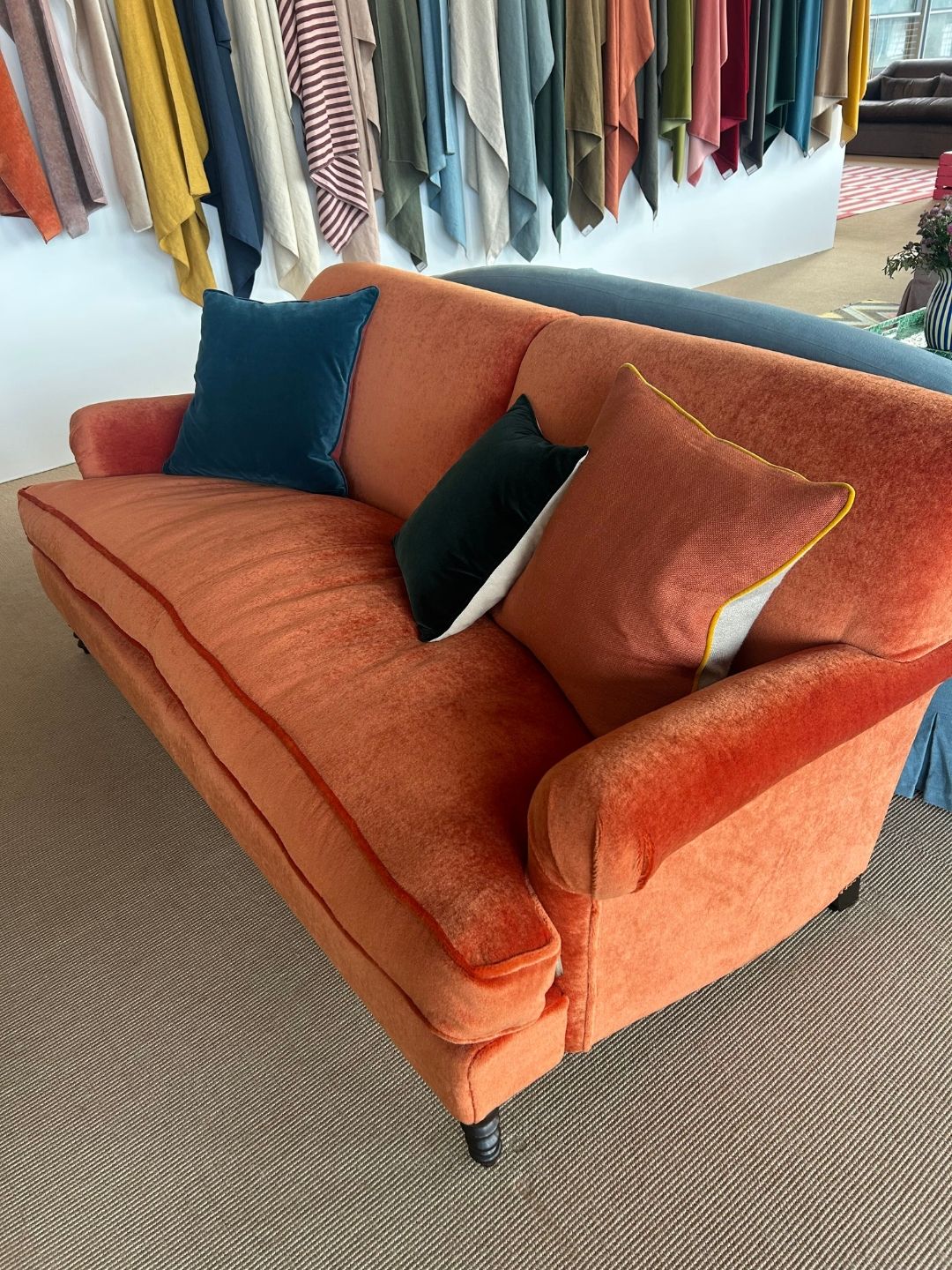 Schplendid's Ablion sofa upholstered in rich Marmalade Mohair, featuring curved arms, deep seat cushions and contrasting colorful custom cushions.
