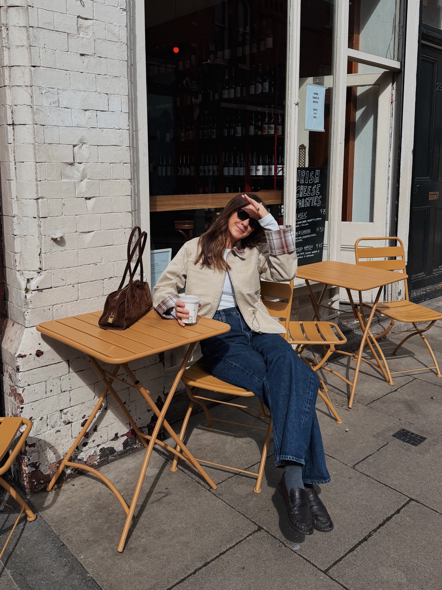 kim turkington wears a utility jacket, jeans and loafers