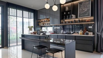 Black kitchen with marble countertops