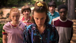 eleven leads a group of teenage friends in Stranger Things