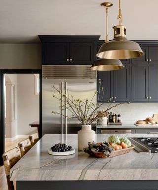 Dark kitchen with large pendant pendant lamps with brass interior