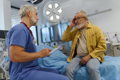  Patient explaining health issues to doctor in examination room.