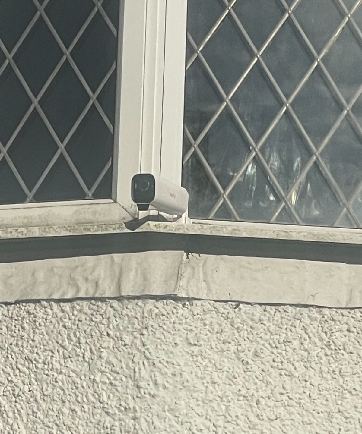 A security camera on a windowsill