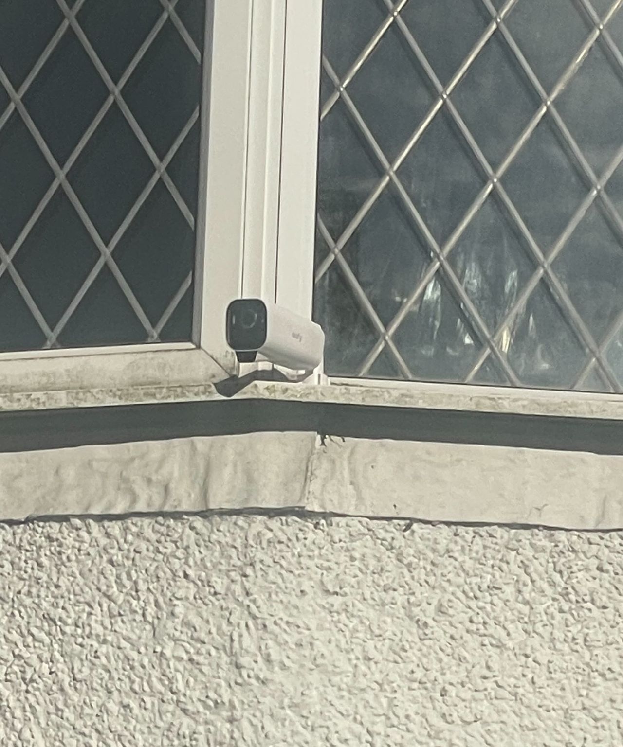 A security camera on a windowsill