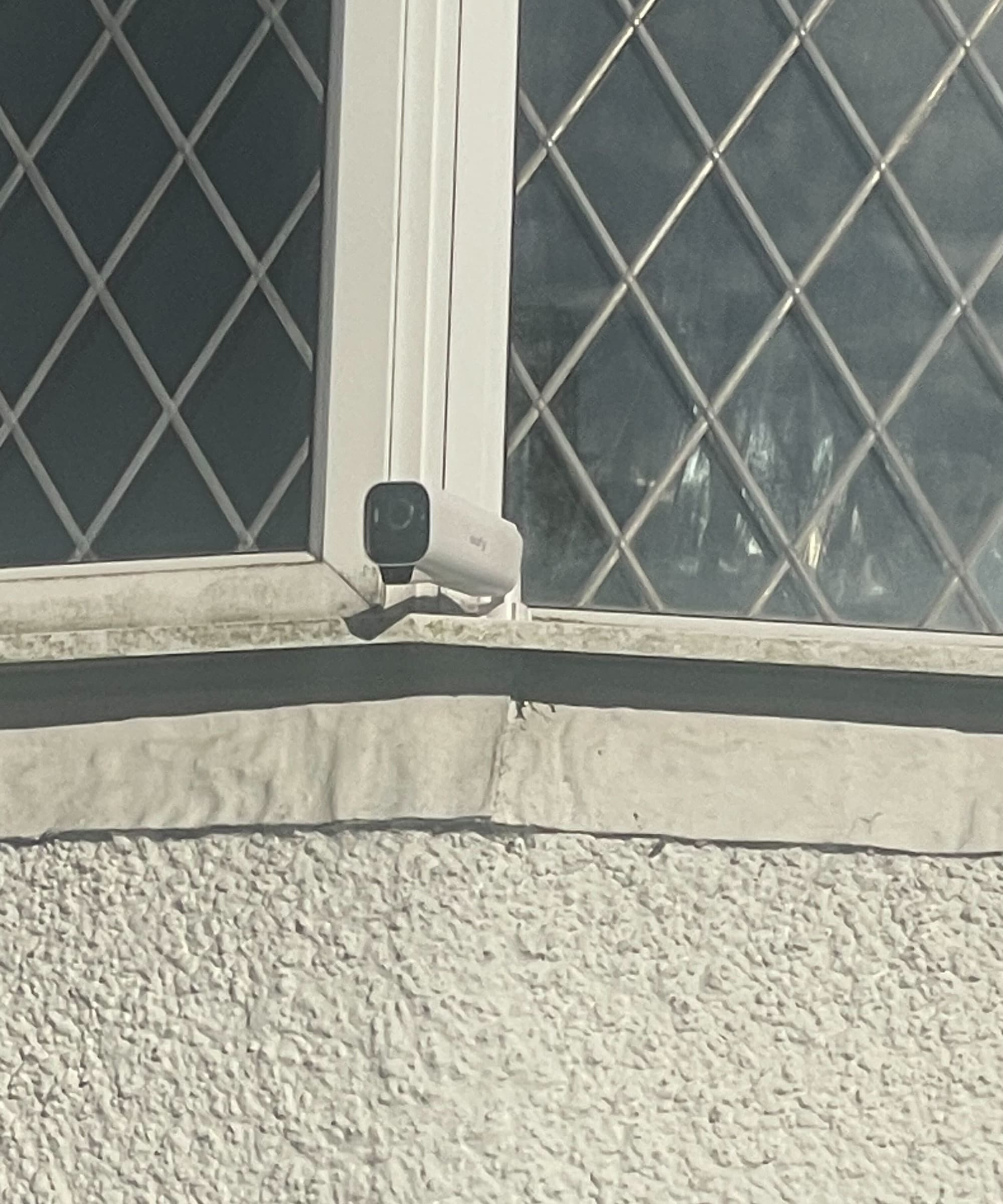 A security camera on a windowsill