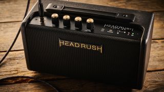 A HeadRush FRFR-Go FRFR speaker on a wooden floor