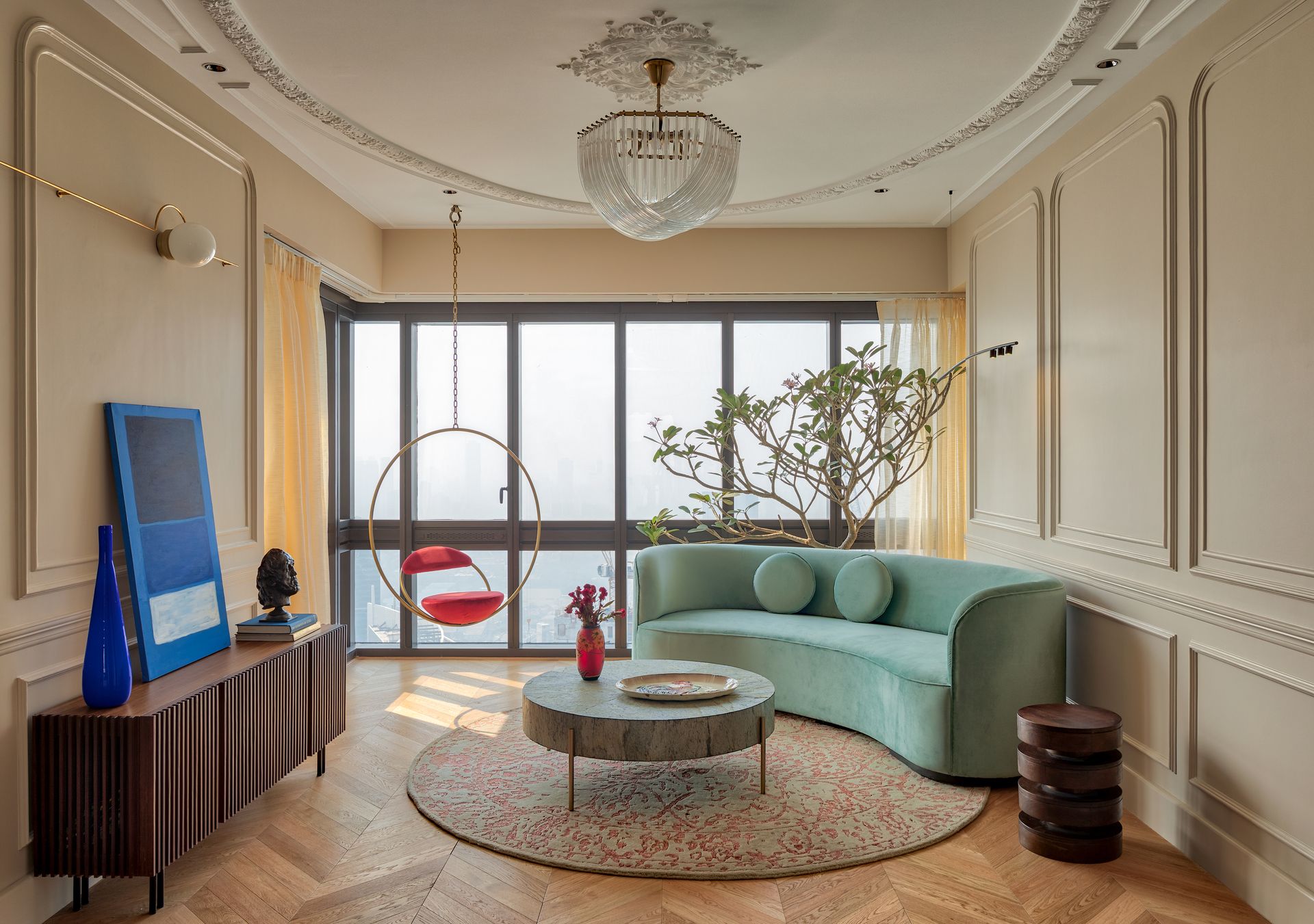 A small living room with a curving green sofa