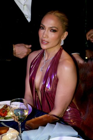 Jennifer Lopez wears shimmering, backless, plunging dress with Harry Kotlar cushion-cut diamond drop necklace