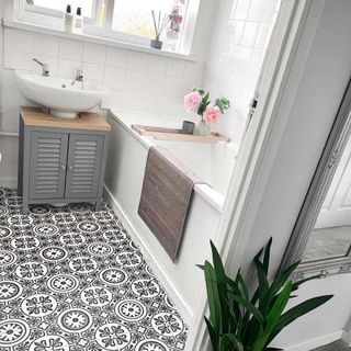 bathroom with textured flooring and flower vase