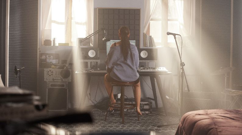 Women in her studio surrounded by Shure microphones