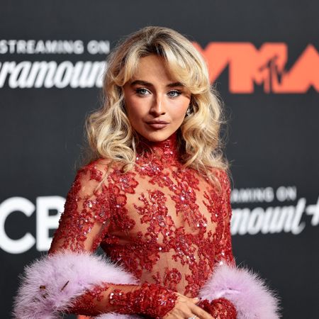 Sabrina Carpenter wears a red lace dress at the 2025 VMAs