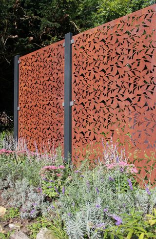 Corten steel decorative screen used in large garden ideas to divide a space