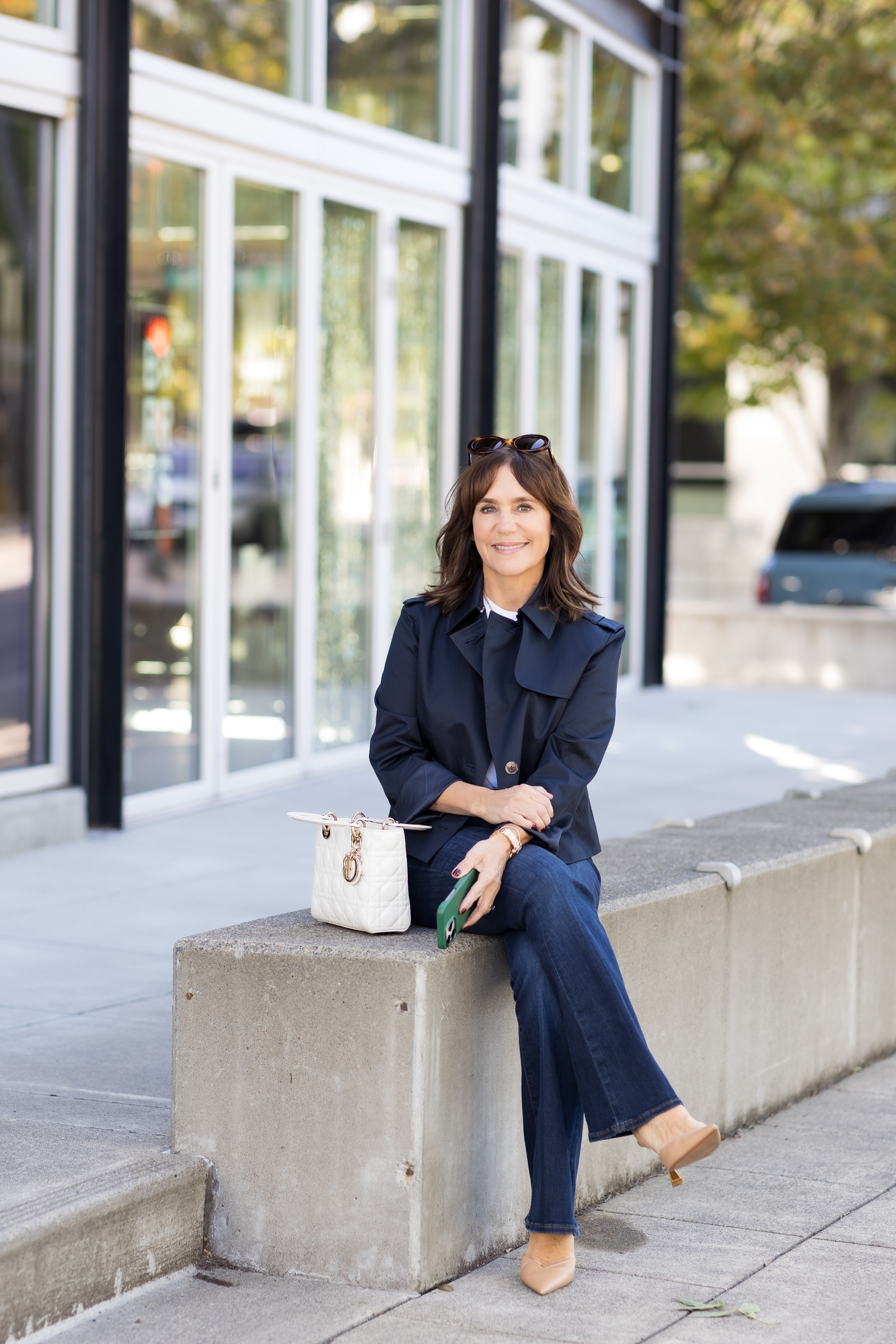 A former Nordstrom buyer wearing a cropped trench coat and jeans.