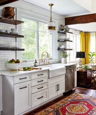 kitchen with white cabinets and blue island