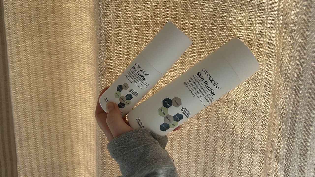 Tori Crowther holding two bottles of the Clinisoothe+ Skin Purifier