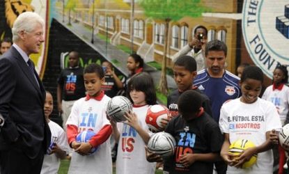 Bill Clinton, chatting with some soccer fans in Harlem, NY, is the honorary chairman of the USA bid Committee to host the FIFIA World Cup in 2018 or 2022.