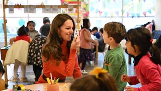 Kate Middleton playing with some children