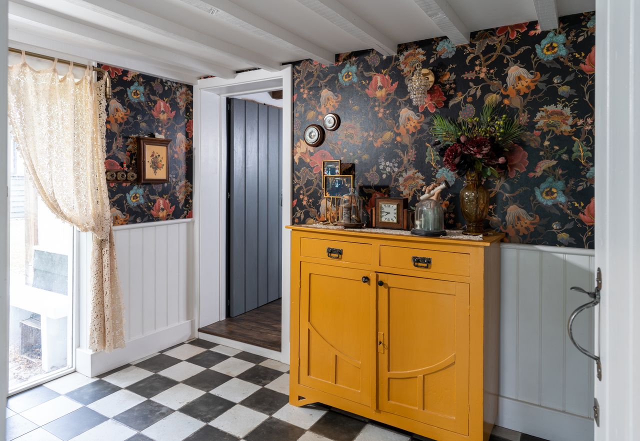 The entrance hall with William Morris-style wallpaper and tiled floor