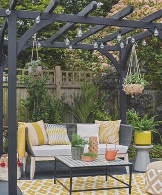 pergola and outdoor seating area with festoon lighting