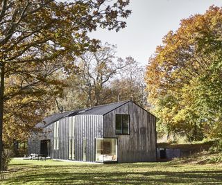 Barn-style new build exterior of zinc and chestnut cladding