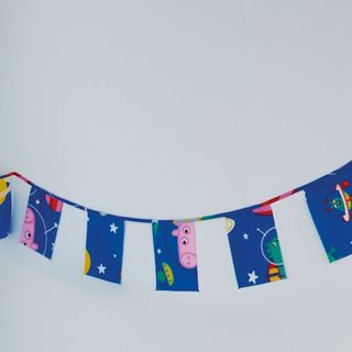 children's bedroom with white wall and blue pig bunting