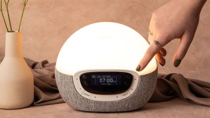Best sunrise alarm clocks: A Lumie sunrise alarm clock on a bedside table