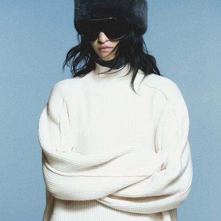 collage of models wearing zara and H&M sweaters on light grey background
