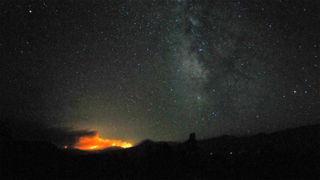 The Dixie Fire On The Horizon Beneath The Milky Way And A Starry Sky