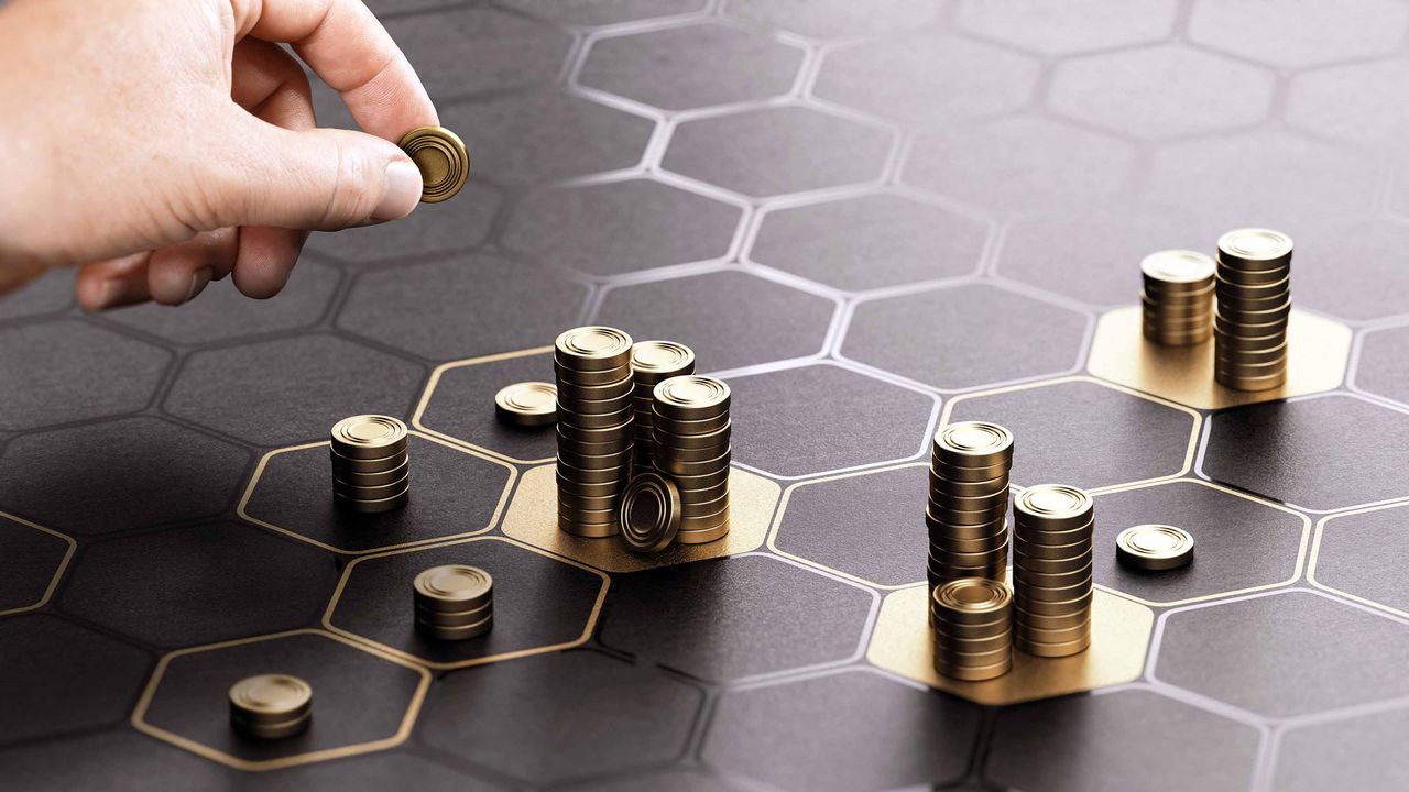 person stacking coins on board