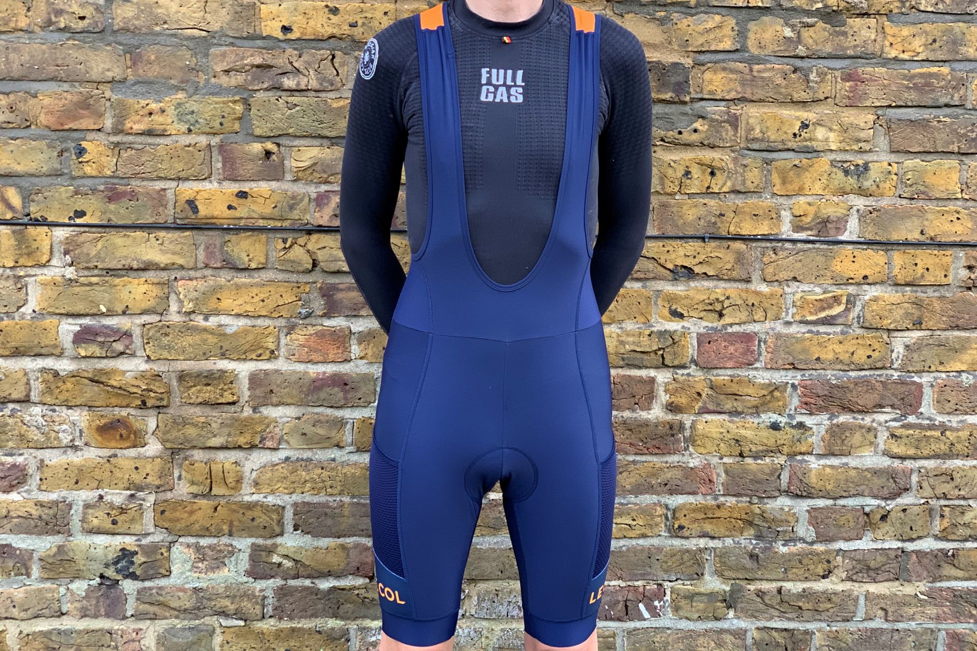Image shows a rider wearing the Le Col Sport Cargo Thermal bib shorts which are among the best bib shorts for cycling