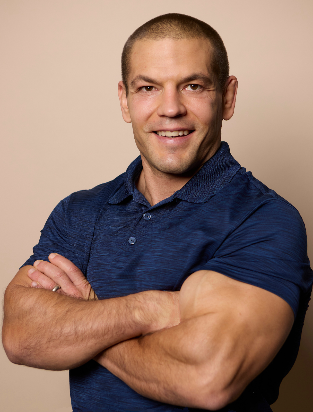 Head and torso of man with his arms crossed