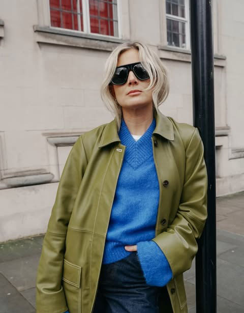 Lucy Williams in a blue sweater and green coat.