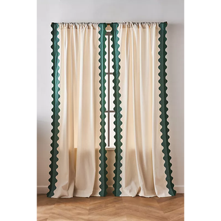 cream-colored curtain with green scalloped edges