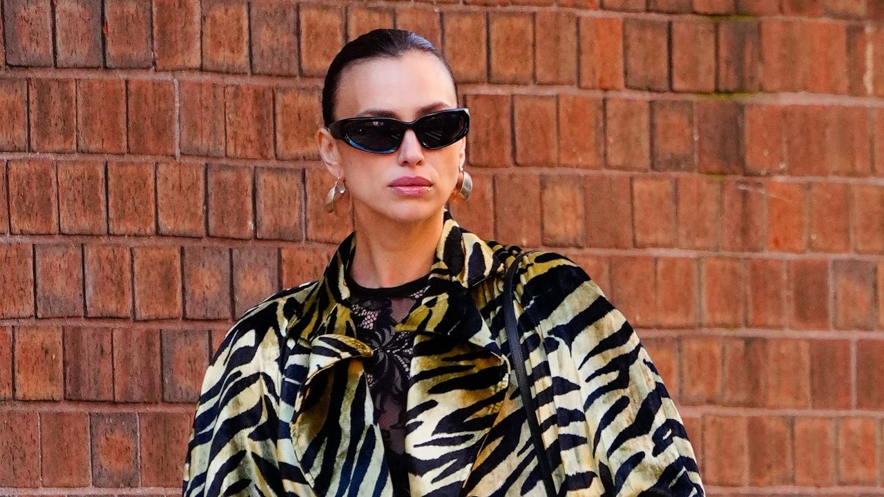 Irina Shayk New Balance sneakers Hermes bag Margiela Gentle Monster sunglasses tiger print coat