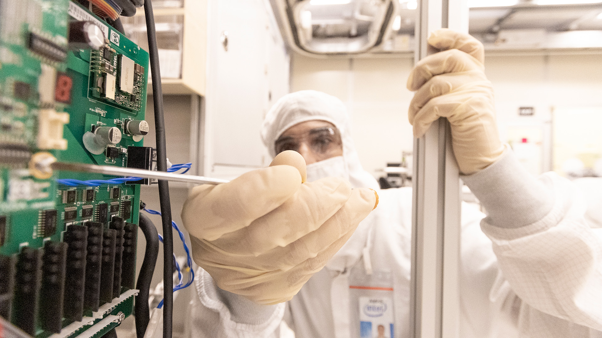 An engineer in Intel&#039;s Fab 28 tinkering with a screw.