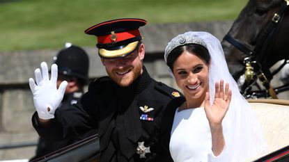WINDSOR, ENGLAND - MAY 19: Prince Harry, Duke of Sussex and Meghan, Duchess of Sussex wave from the Ascot Landau Carriage during their carriage procession on Castle Hill outside Windsor Castle on May 19, 2018 in Windsor, England. (Photo by Paul Ellis - WPA Pool/Getty Images)