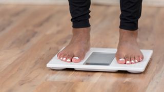 woman's feet standing on a pair of scales