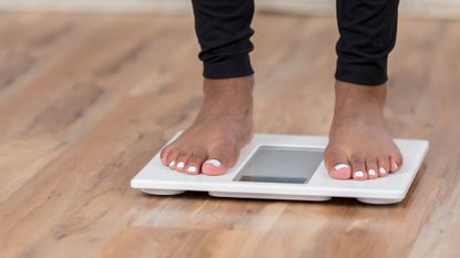 woman's feet standing on a pair of scales