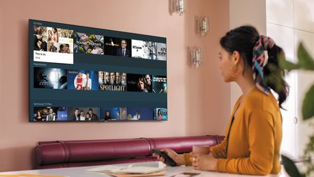 Samsung TV being used by a woman in an orange cardigan