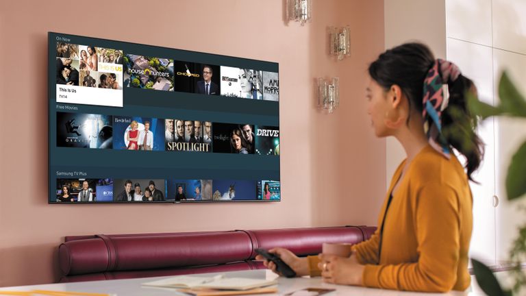 Samsung TV being used by a woman in an orange cardigan